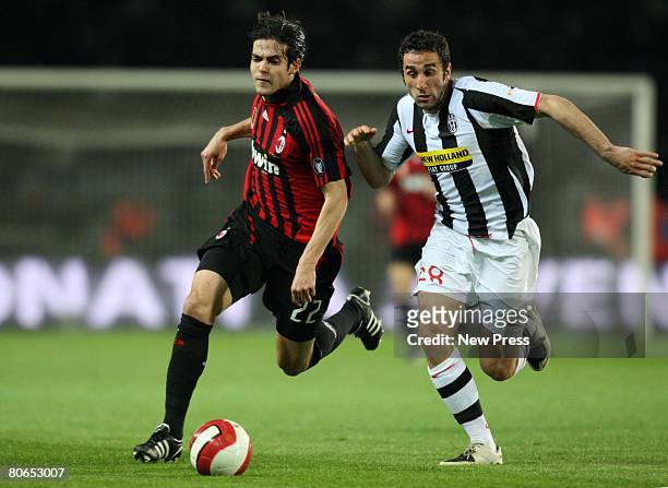 Ricardo Kaka of Milan and Cristian Molinaro of Juventus in action during the Serie A match between Juventus and Milan at the Stadio Olimpico on April...
