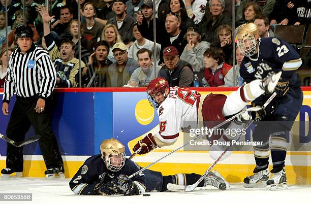 Nick Petrecki of the Boston College Golden Eagles goes aireborne as he battle Kyle Lawson and Mark Van Guilder of the Notre Dame Fighting Irish for...