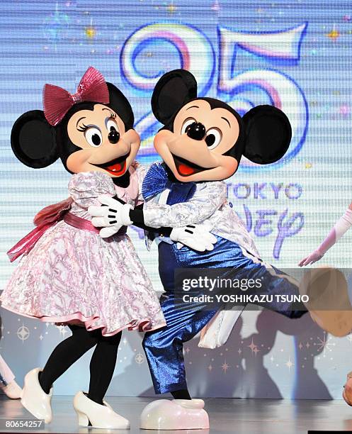 Mickey and Minnie Mouse perform at a press event for the 25th anniversary of the Tokyo Disneyland at Urayasu in Chiba prefecture on April 10, 2008....
