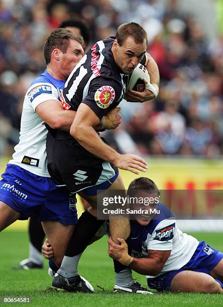 Simon Mannering of the Warriors gets tackled during the round five NRL match between the Warriors and the Bulldogs at Mt Smart Stadium on April 13,...