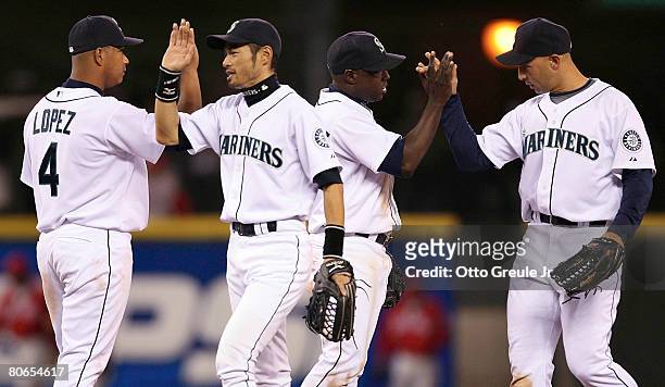 Jose Lopez, Ichiro Suzuki, Yuniesky Betancourt, and Raul Ibanez of the Seattle Mariners celebrate after defeating the Los Angels Angels of Anaheim...