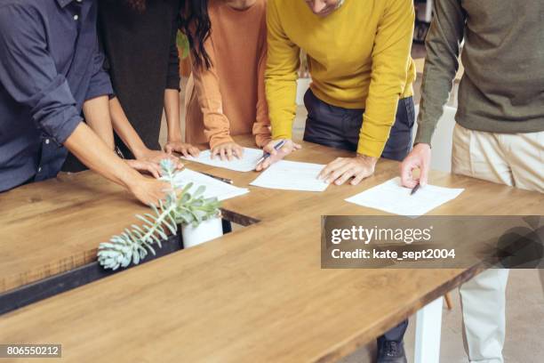 brainstorming financial advice - model signing contract stock pictures, royalty-free photos & images