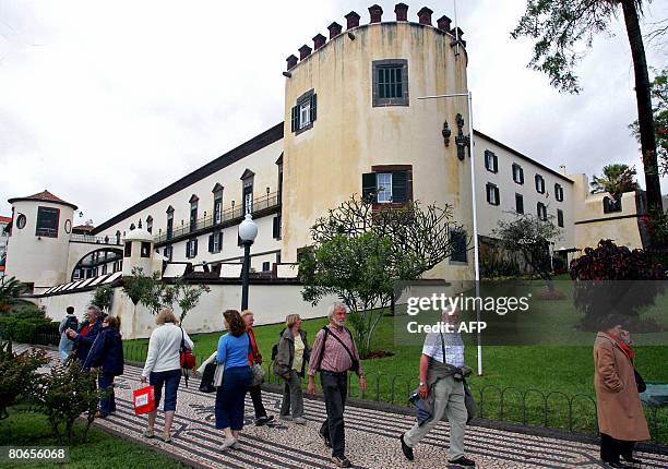 People walk past by Palacio de Sao Lourenco in the center of Funchal, the capital of the Portuguese autonomous archipelo of Madeira, on April 9,...