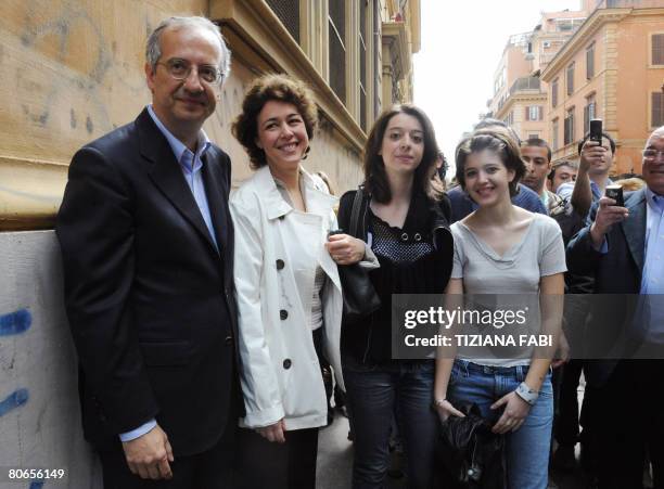 Centre-left leader Walter Veltroni poses with his wife Flavia and his daughters Martina and Vittoria after leaving the polling station in Rome on...