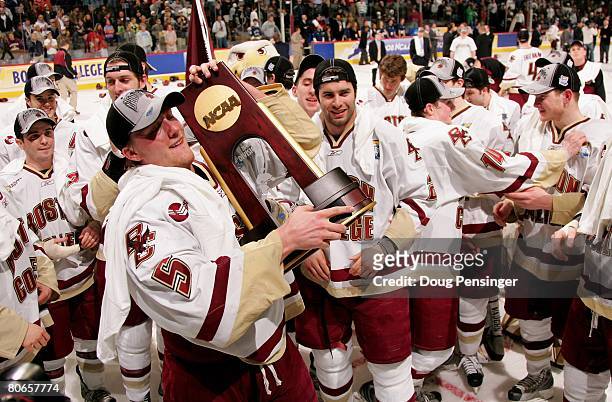 Tim Filangieri of the Boston College Golden Eagles hoists the trophy as they celebrate defeating the Notre Dame Fighting Irish 4-1 in the 2008 NCAA...