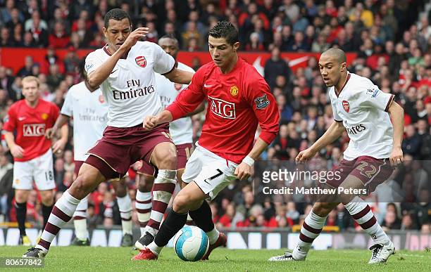 Cristiano Ronaldo of Manchester United clashes with Gilberto and Gael Clichy of Arsenal during the Barclays FA Premier League match between...
