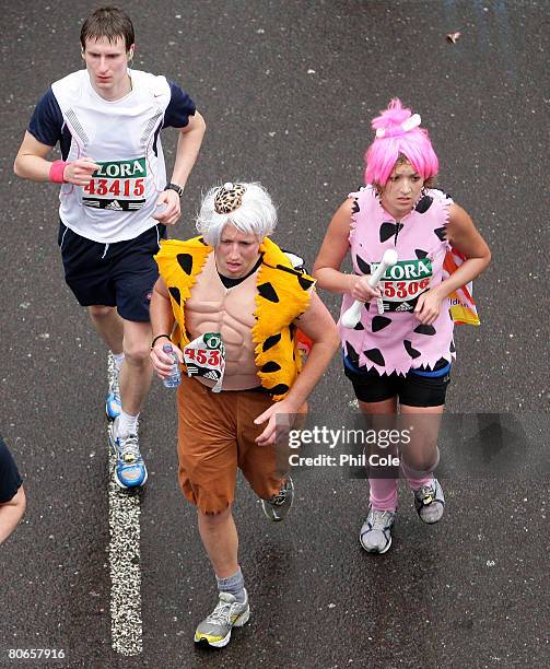 Couple dressed up as the Flinstones goes under Waterloo Bridge during the 2008 Flora London Marathon on April 13, 2008 in London, England.