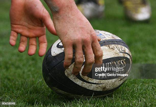 Player picks up a Guinness rugby ball during the Guinness Premiership match between Leeds Carnegie and Harlequins at Headingley Stadium on April 13,...