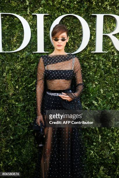 Model Bella Hadid poses as she arrives for the opening of the Dior exhibition that celebrates the seventieth anniversary of the Christian Dior...