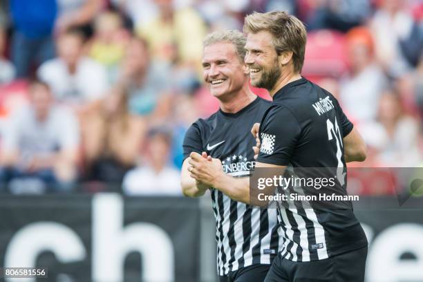 Moritz Fuerste of Schumacher and Friends celebrates his team's first goal with team mate David Coulthard during the Champions for Charity Friendly...