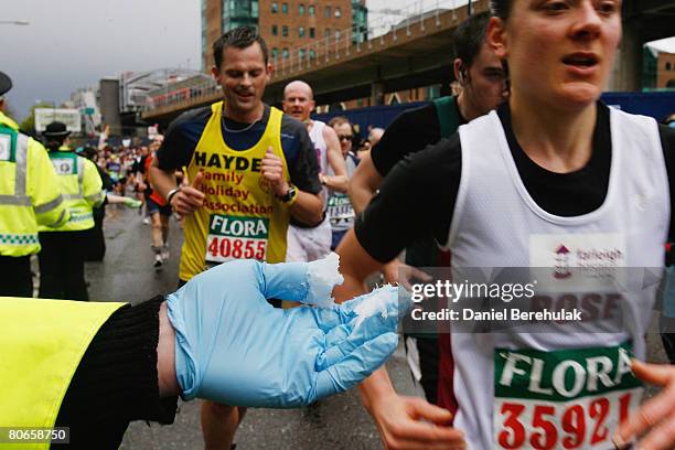 St John's Ambulance worker holds out vaseline for runners during the 2008 Flora London Marathon on April 13, 2008 in London, England.
