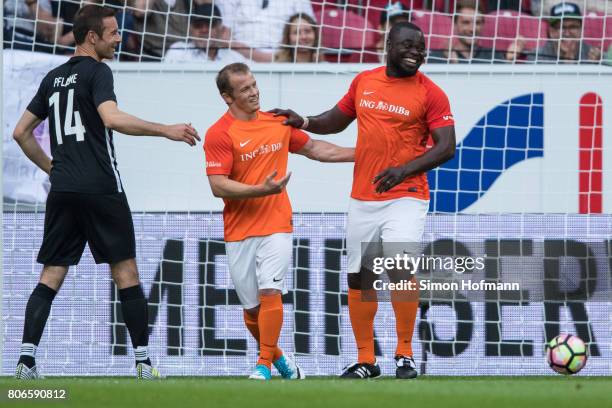 Gerald Asamoah of Nowitzki All Stars celebrates a goal with team mate Fabian Hambuechen during the Champions for Charity Friendly match at Opel Arena...