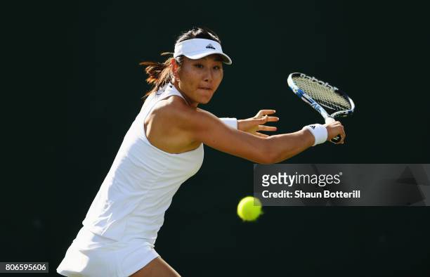 Ying-Ying Duan of China plays a backhand during the Ladies Singles first round match against Ana Bogdan of Romania on day one of the Wimbledon Lawn...