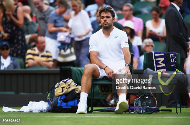 Stan Wawrinka of Switzerland puts ice on his knee during the Gentlemen's Singles first round match against Daniil Medvedev of Russia on day one of...