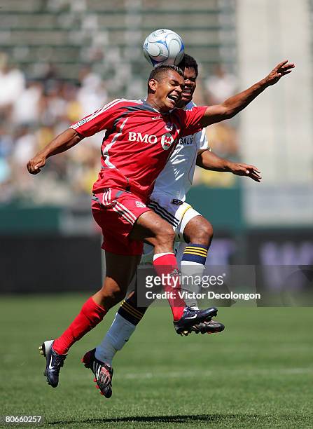 Newly-acquired Honduran national Amado Guevara of Toronto FC vies for a header with Alvaro Pires of the Los Angeles Galaxy in the second half during...