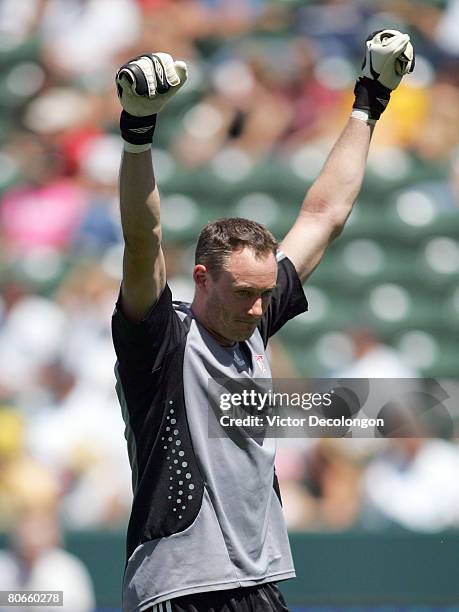 Goalkeeper Greg Sutton of Toronto FC raises his arms after teammate Jeff Cunningham scored the go-ahead eventual game-winning goal late in the second...