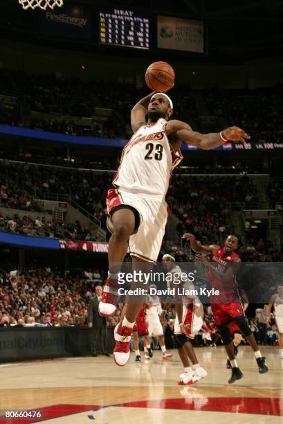 LeBron James of the Cleveland Cavaliers rises high for the fast break dunk against the Miami Heat at the Quicken Loans Arena April 13, 2008 in...
