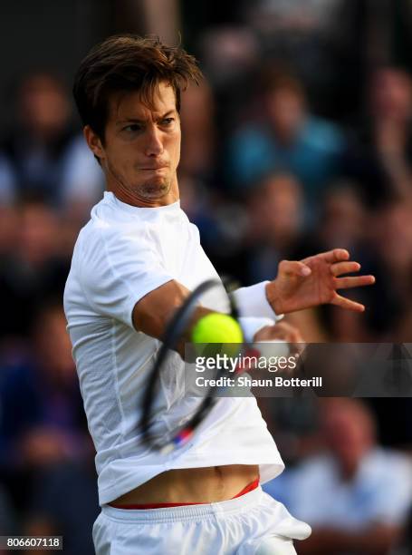 Aljaz Bedene of Great Britain plays a forehand during the Gentlemen's Singles first round match against Ivo Karlovic of Croatia on day one of the...