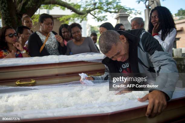 Luis Carlos de Oliveira mourns his relatives Ana Cristina da Conceicao and her mother, Marlene Maria da Conceicao killed Friday by stray bullets...