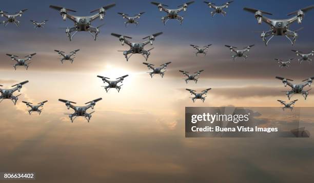 flock of drones in the sky at sunset - drone stock pictures, royalty-free photos & images