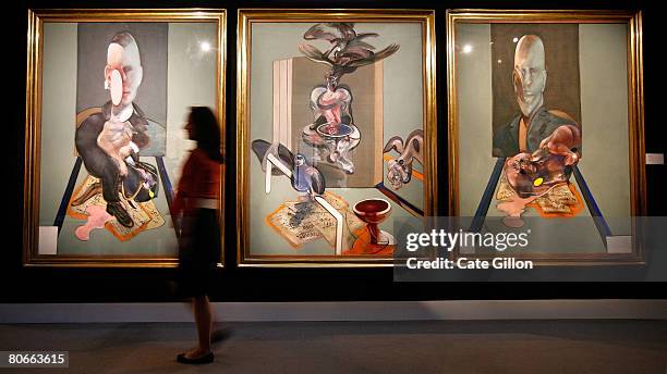 Sotheby's employee passes in front of Francis Bacon's triptych on April 14, 2008 in London, England. The artwork, estimated to sell for 70 million...