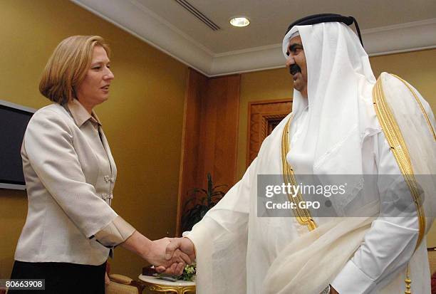 In this handout image supplied by the Israeli Government Press Office , Israeli Foreign Minister Tzipi Livni is greeted by Qatari Emir Sheikh Hamad...