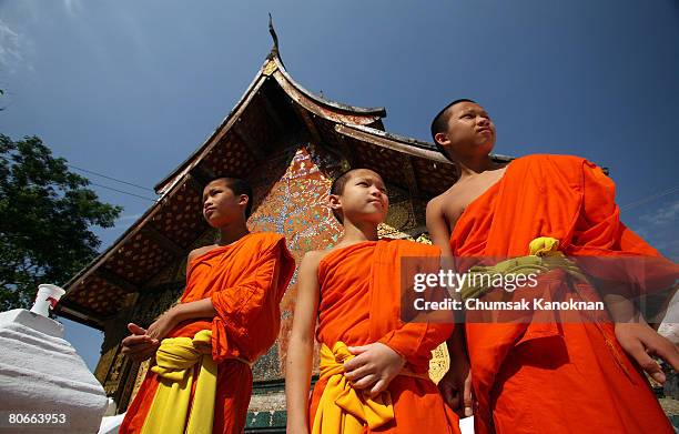 Laos Buddhist monks stand next to Wat Xieng Thong during the Songkran festival on April 14 in Luang Prabang, Laos. . The Songkran Festival runs from...