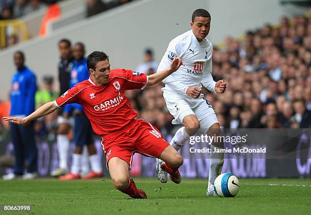 Jermaine Jenas of Tottenham Hotspur is tackled by Stewart Downing of Middlesbrough during the Barclays Premier League match between Tottenham Hotspur...