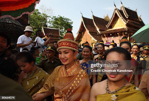 Laos women in acient custome parade pass Wat Xieng Thong during the Songkran festival on April 14 in Luang Prabang, Laos. The Songkran Festival runs...