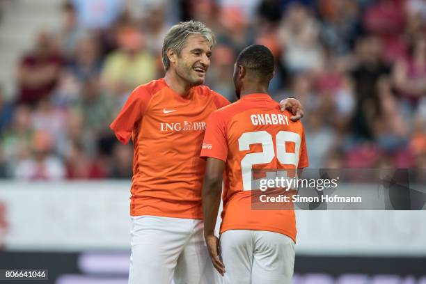 Gerd Schoenfelder of Nowitzki All Stars hugs Serge Gnabry during the Champions for Charity Friendly match at Opel Arena on July 3, 2017 in Mainz,...