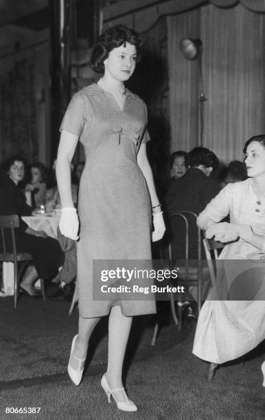 Teenage debutante Diane Kirk models a Pierre Cardin dress at the Berkeley Hotel, London, 17th March 1958. French fashion designer Cardin is judge at...