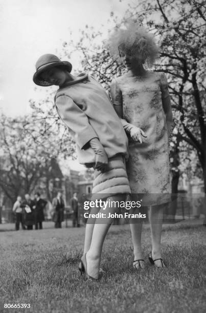 Teenage debutantes Diane Kirk and the Hon Penelope Allsopp, modelling outfits by French fashion designer Pierre Cardin in Green Park, London, 28th...