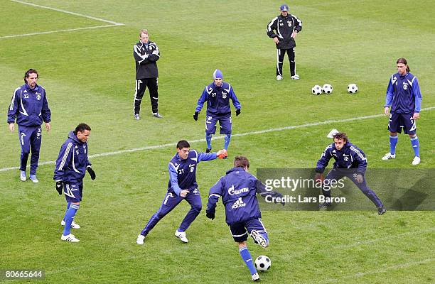 New coach Mike Bueskens observes the players during the warm up during a FC Schalke 04 training session at the Veltins Arena on April 14, 2008 in...