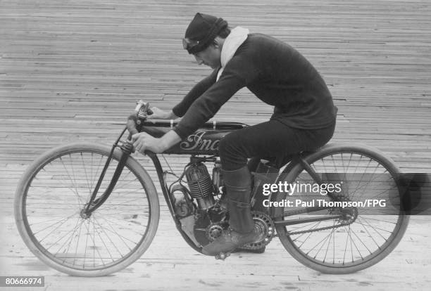 American motocycling champion Jacob de Rosier riding his Indian motorcycle at a velodrome, circa 1910.