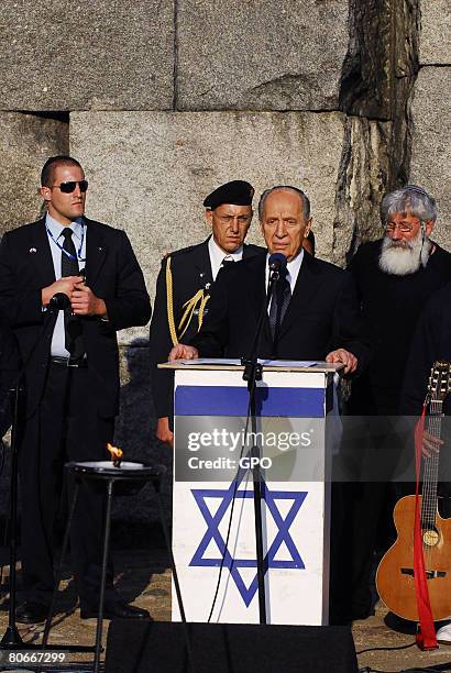 Israeli President Shimon Peres speaks as he and Polish President Lech Kaczynski attend a memorial service at the site of the Treblinka death camp on...