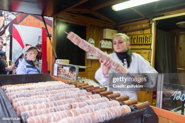 traditional czech pastry ''trdelnik'' street vendor at the old town square in prague - trdelník stock pictures, royalty-free photos & images