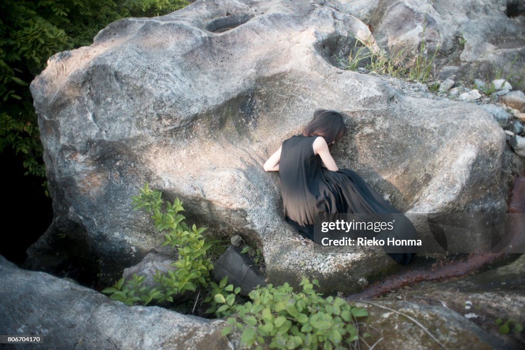 Woman lying on a rock