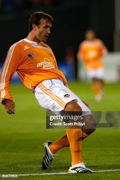 Bobby Boswell of the Houston Dynamo crosses the ball against the Kansas City Wizards during the game at Community America Ballpark on April 12, 2008...