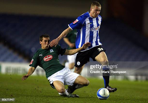 Bartosz Slusarski of Sheffield Wednesday tangles with Gary Sawyer of Plymouth Argyle during the Coca-Cola Championship match between Sheffield...