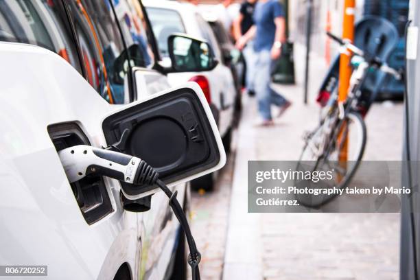 electric car being charged - elektrische auto stockfoto's en -beelden