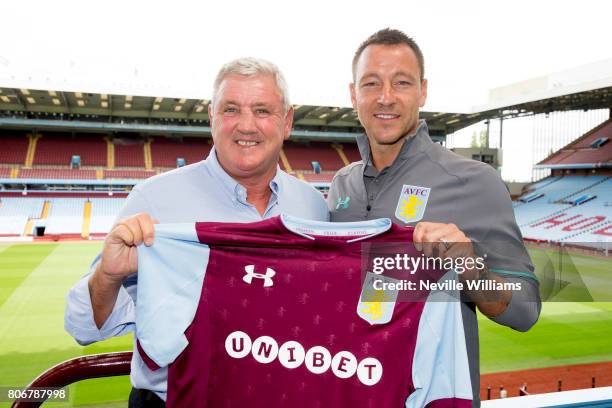 New signing John Terry of Aston Villa and Steve Bruce manager of Aston Villa pose for a picture at Villa Park on July 03, 2017 in Birmingham, England.