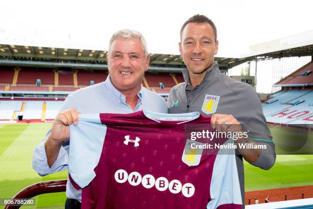 New signing John Terry of Aston Villa and Steve Bruce manager of Aston Villa pose for a picture at Villa Park on July 03, 2017 in Birmingham, England.