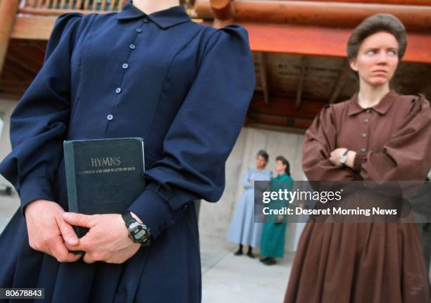 Woman of the Fundamentalist Church of Jesus Christ of Latter Day Saints holds a hymn book, which is the only thing she was allowed to take when she...