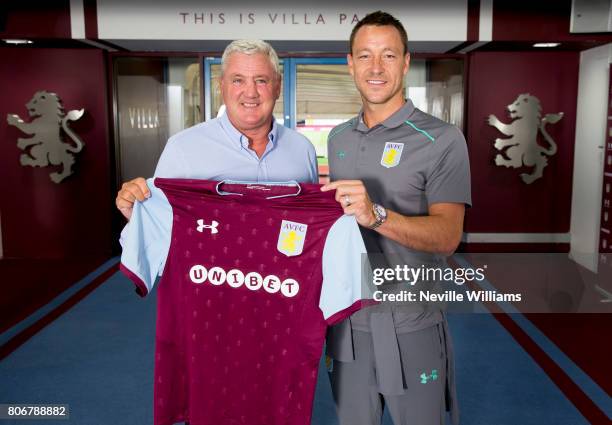 New signing John Terry of Aston Villa and Steve Bruce manager of Aston Villa pose for a picture at Villa Park on July 03, 2017 in Birmingham, England.