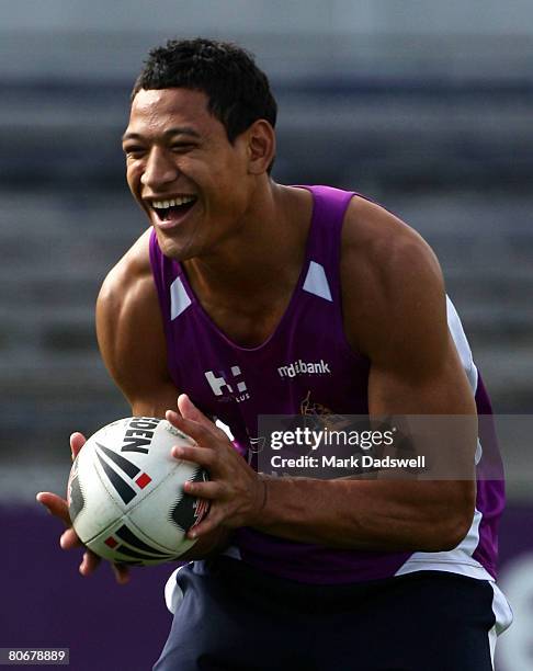 Israel Folau of the Storm has a laugh during the warm up during a Melbourne Storm NRL training session at MC Labour Park on April 15, 2008 in...