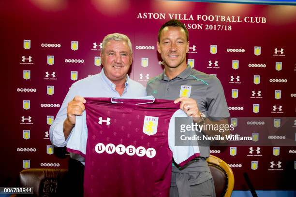New signing John Terry of Aston Villa and Steve Bruce manager of Aston Villa pose for a picture at Villa Park on July 03, 2017 in Birmingham, England.