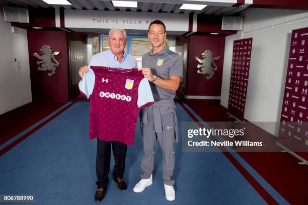 New signing John Terry of Aston Villa and Steve Bruce manager of Aston Villa pose for a picture at Villa Park on July 03, 2017 in Birmingham, England.