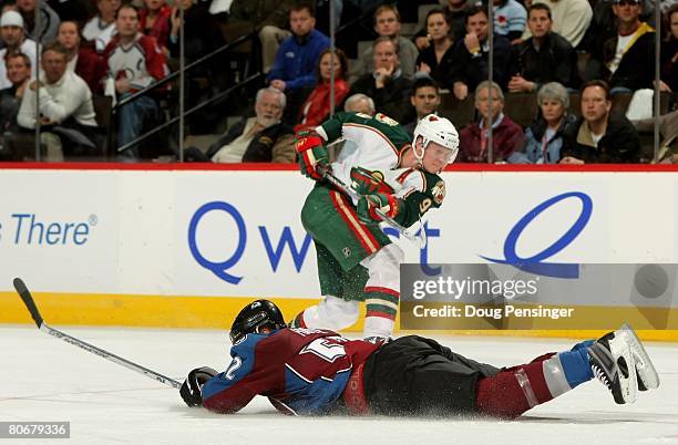 Adam Foote of the Colorado Avalanche dives to the ice to block a shot by Pierre-Marc Bouchard of the Minnesota Wild during game three of the 2008 NHL...