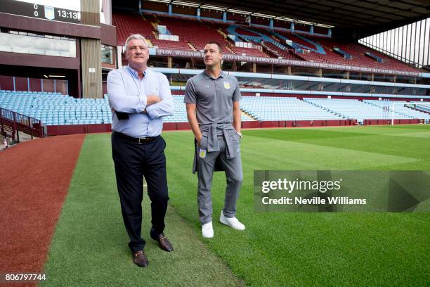 New signing John Terry of Aston Villa and Steve Bruce manager of Aston Villa pose for a picture at Villa Park on July 03, 2017 in Birmingham, England.