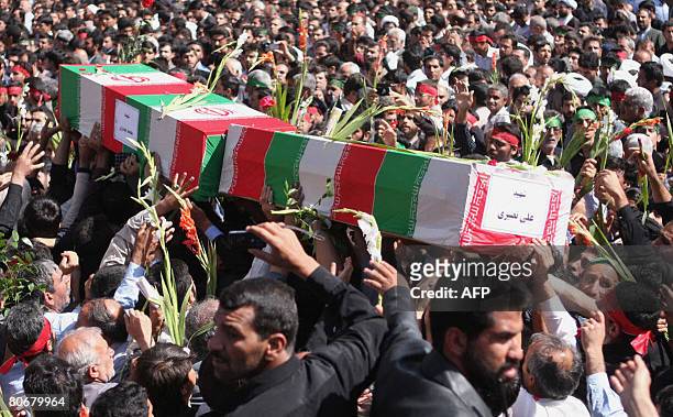 Iranians carry the coffins at the Shah Cheragh shrine of Shiraz on April 15, 2008 during the funeral of the people who were killed in a mosque blast...